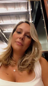 Anna Volpi, con abbigliamento bianco e sfondo architettonico